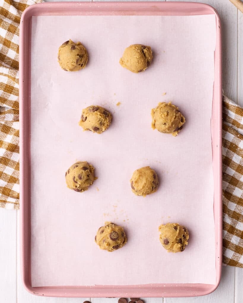 Brown butter chocolate chip cookie dough balls on a baking sheet. 