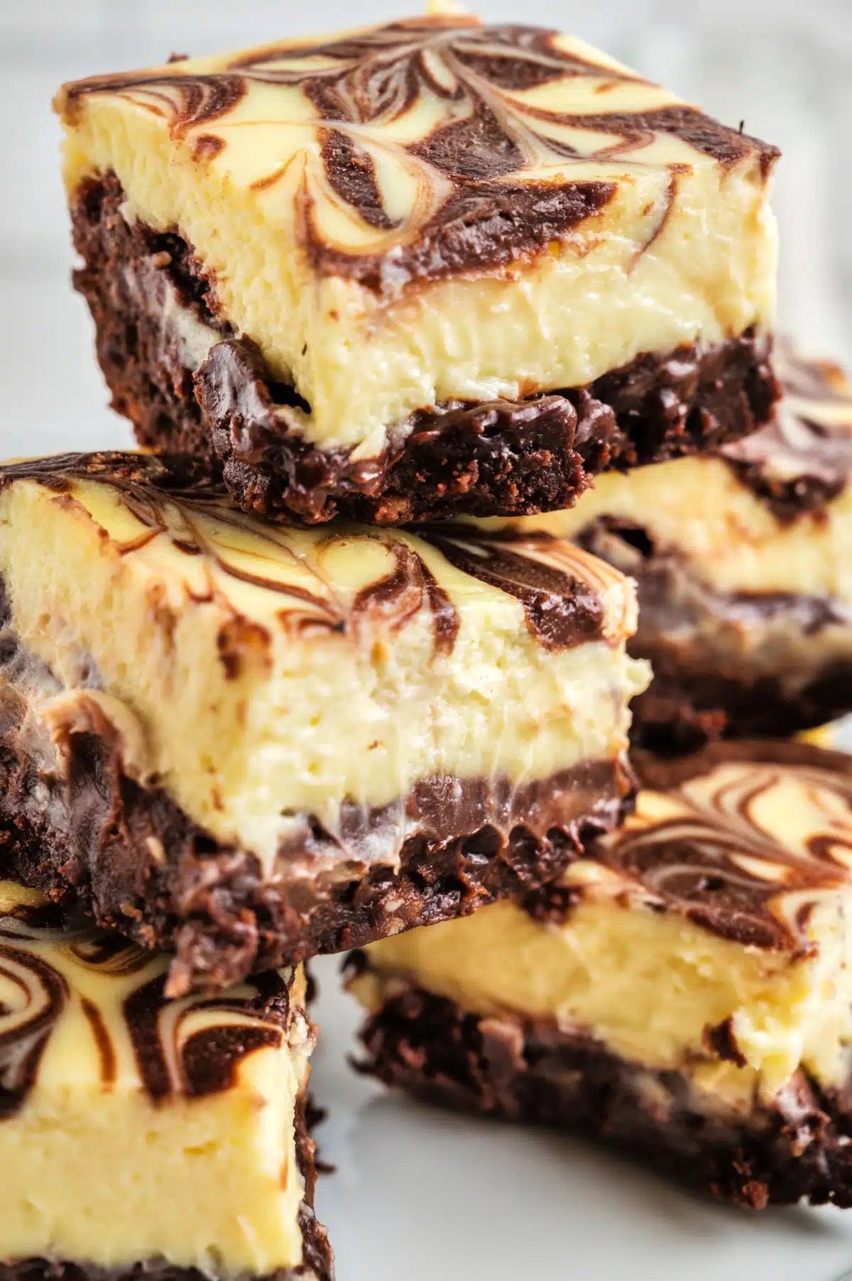 Close up of a stack of cheesecake brownies.