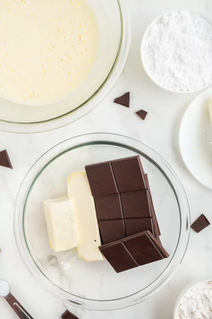 melting butter and chocolate together to make cheesecake brownies.