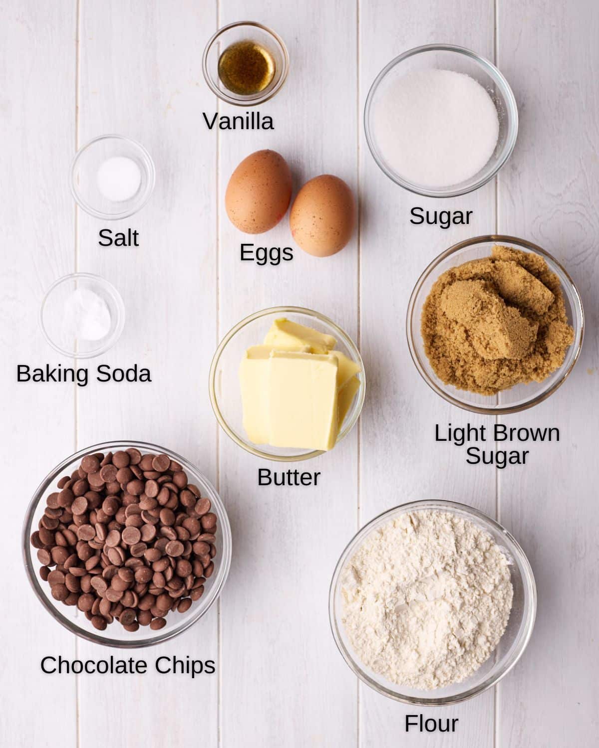 Ingredients to make brown butter chocolate chip cookies, including butter, sugar, light brown sugar, flour, eggs, salt, vanilla, baking soda, and chocolate chips.  