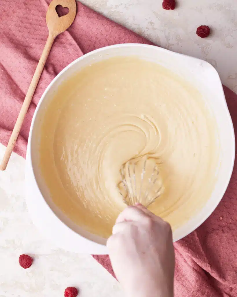 process shot of whisking raspberry muffin batter.