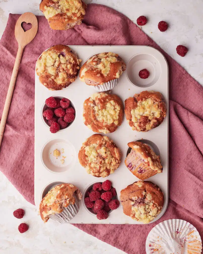 Raspberry muffins in a muffin pan.