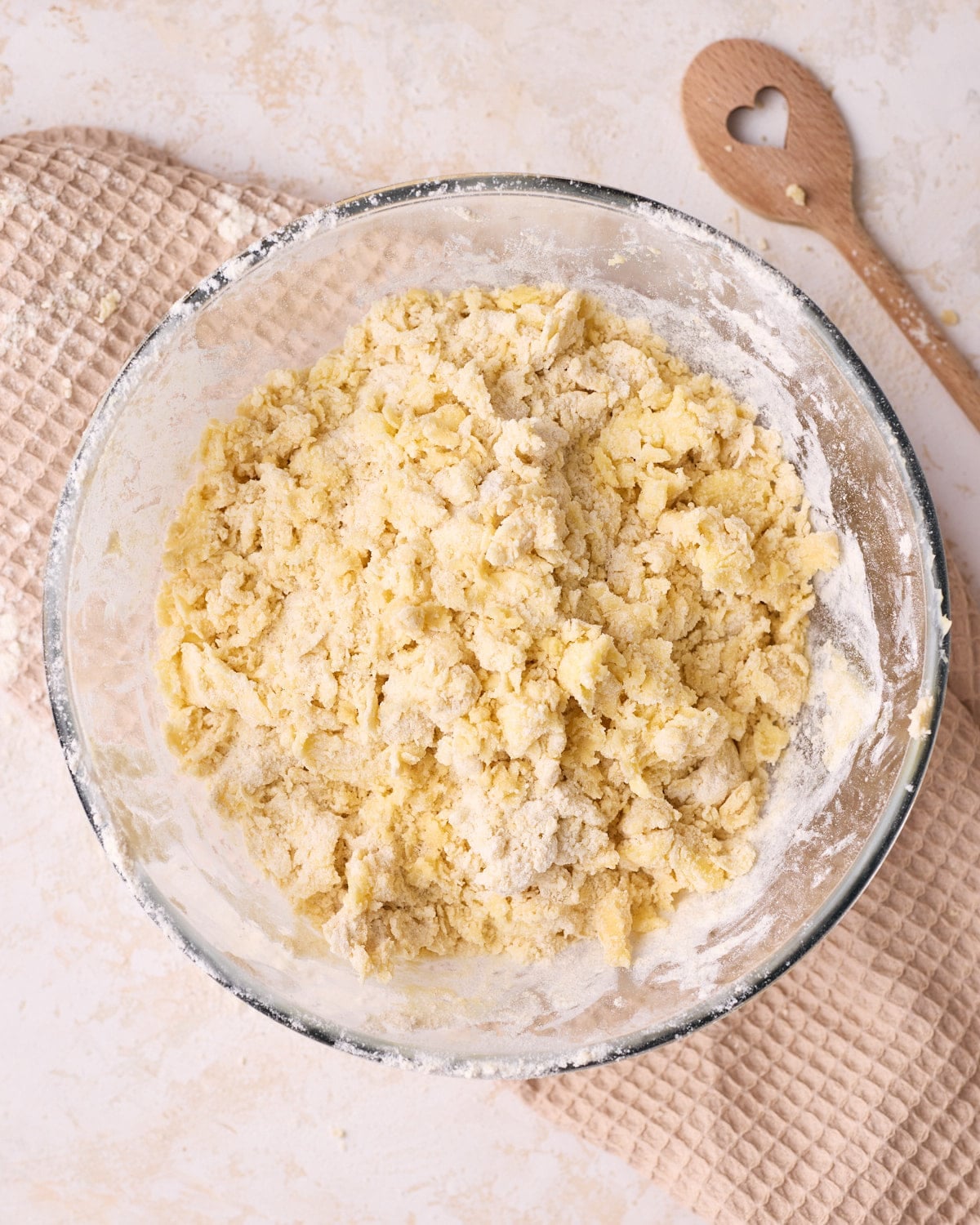 Mixing flour into butter and sugar to make shortbread dough.