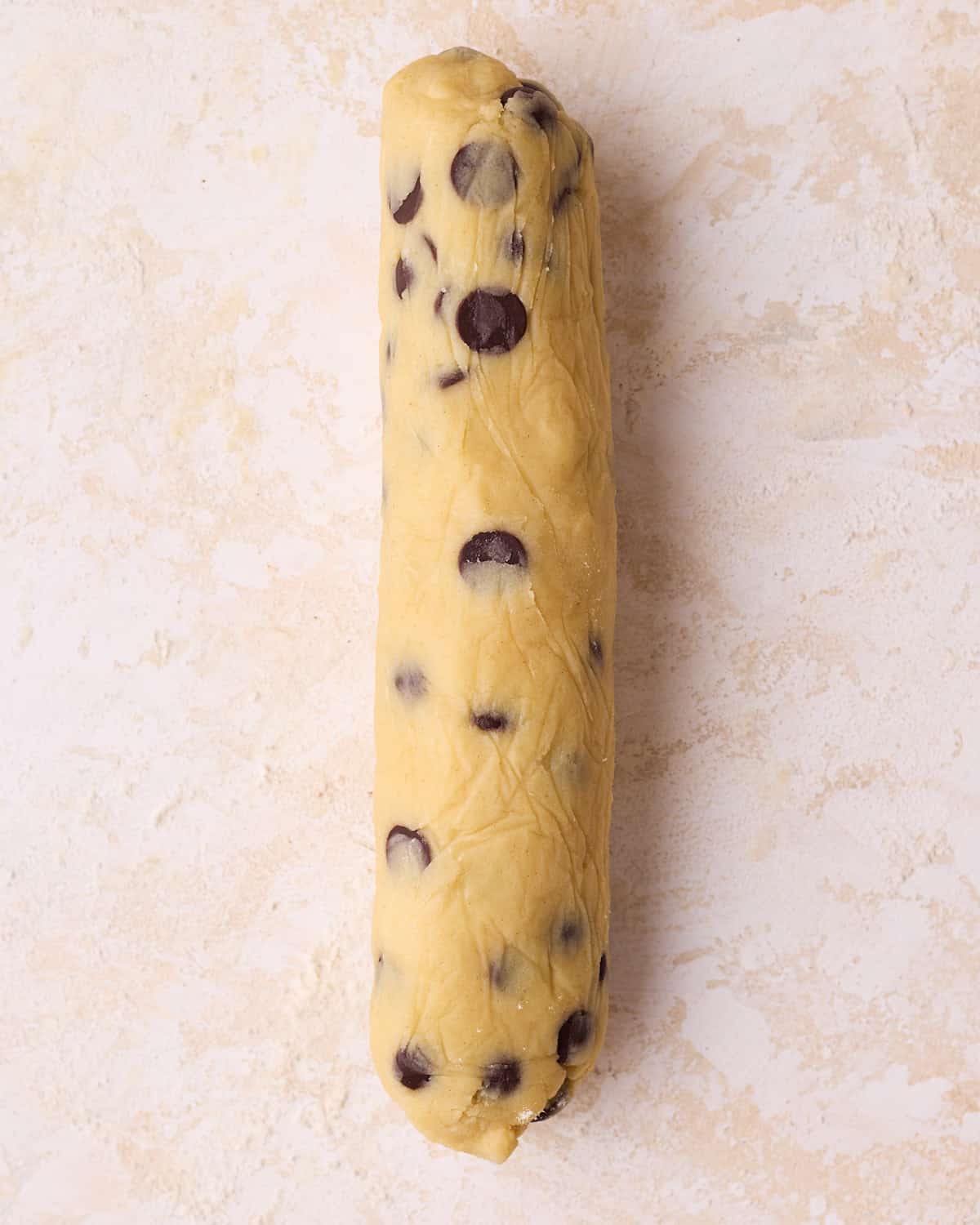 A log of shortbread dough that has been rolled out for the slice and bake method of making shortbread cookies.