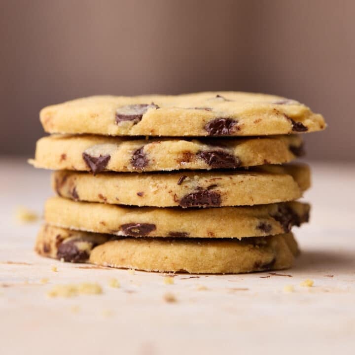 A stack of five heart shaped chocolate chip shortbread cookies on top of each other.