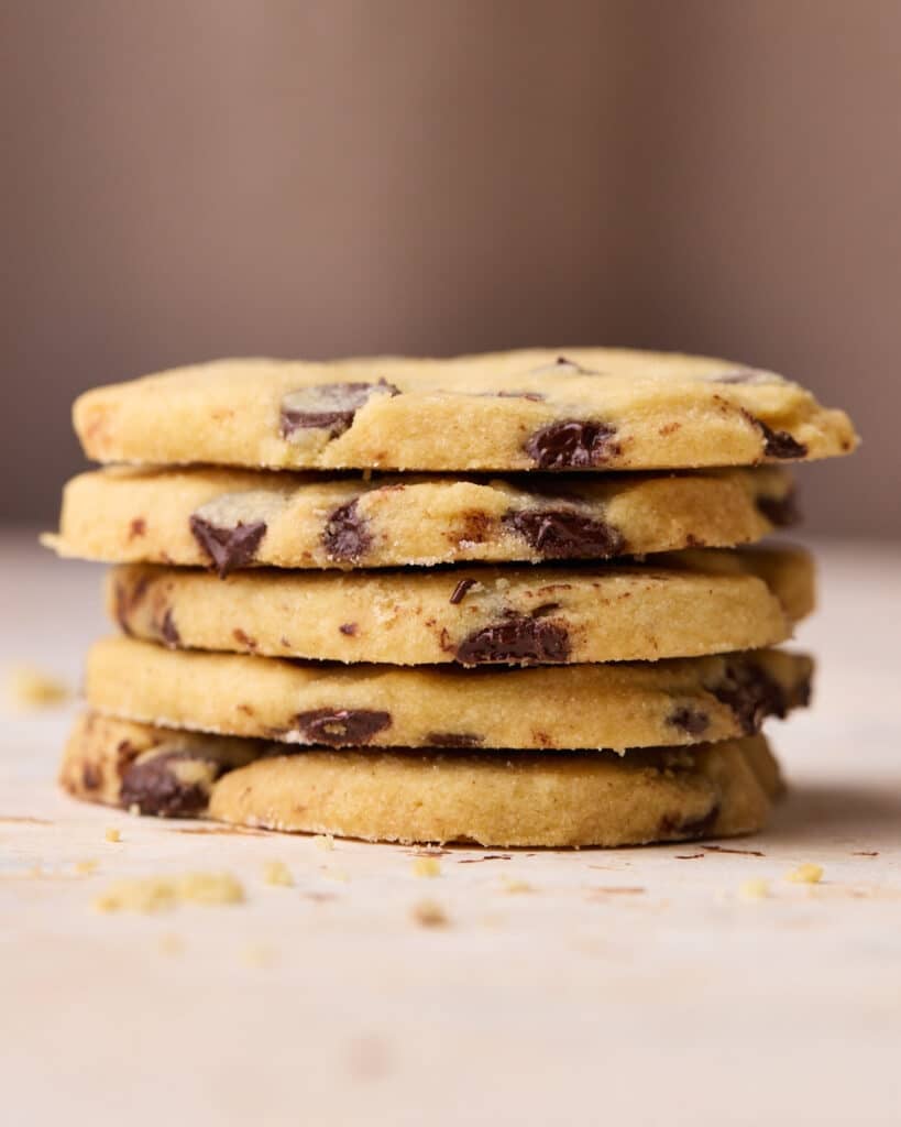 A stack of five heart shaped chocolate chip shortbread cookies on top of each other.