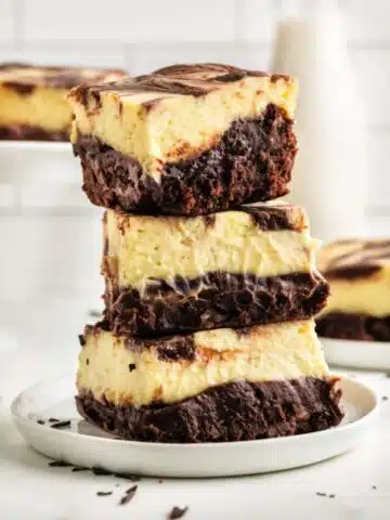 Gooey cheesecake brownies in a stack.