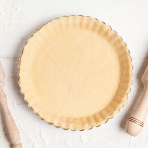 Overhead view of shortcrust pastry in a tart pan, ready to be baked.