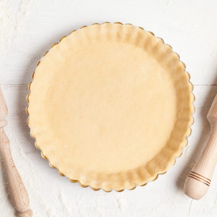 Overhead view of shortcrust pastry in a tart pan, ready to be baked.