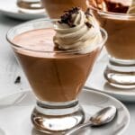 three glass dishes with baileys chocolate mousse in them and whipped cream on top.