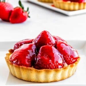 A strawberry custard tart with strawberry glaze on top.