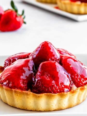 A strawberry custard tart with strawberry glaze on top.