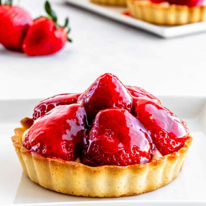 A strawberry custard tart with strawberry glaze on top.