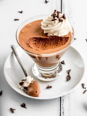 French Chocolate Mousse in a serving glass with a spoonful taken out.