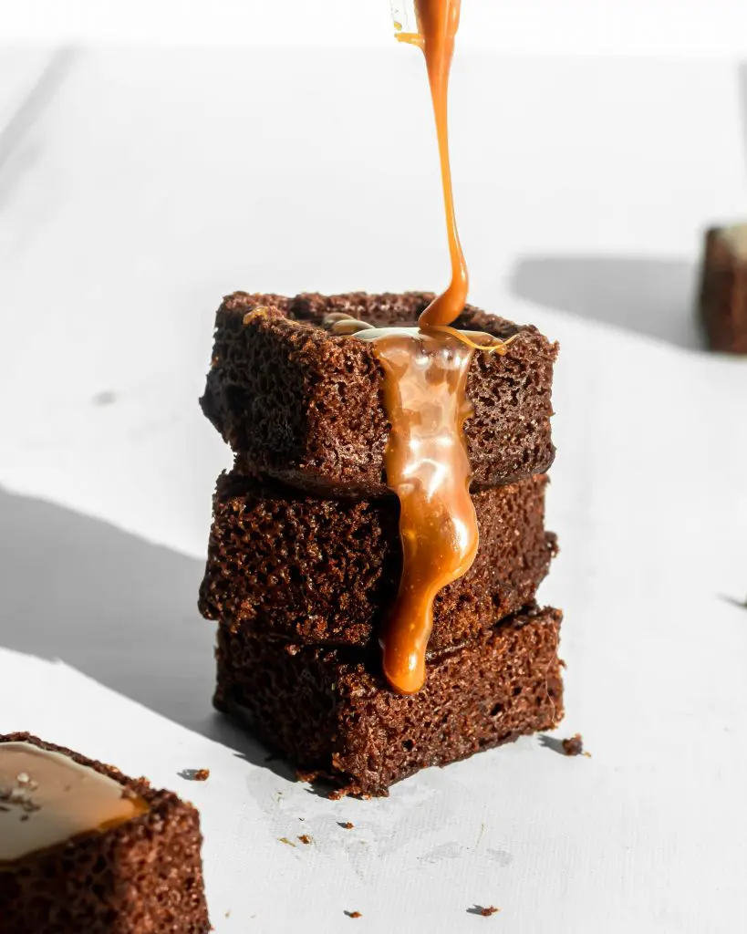 caramel being drizzled over chocolate and salted caramel bites
