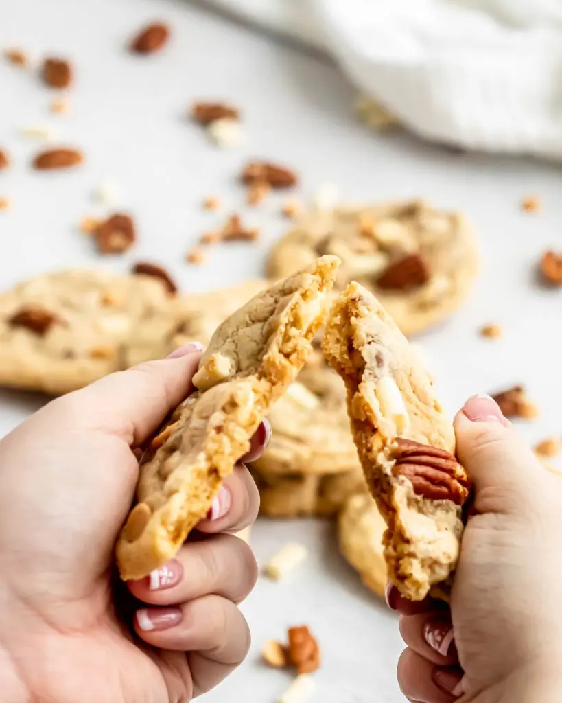 white chocolate pecan and butterscotch cookie broken in half