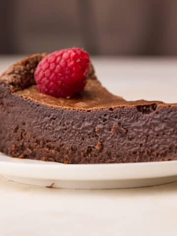 Slice of chocolate torte from the side to show the custard-like texture inside.