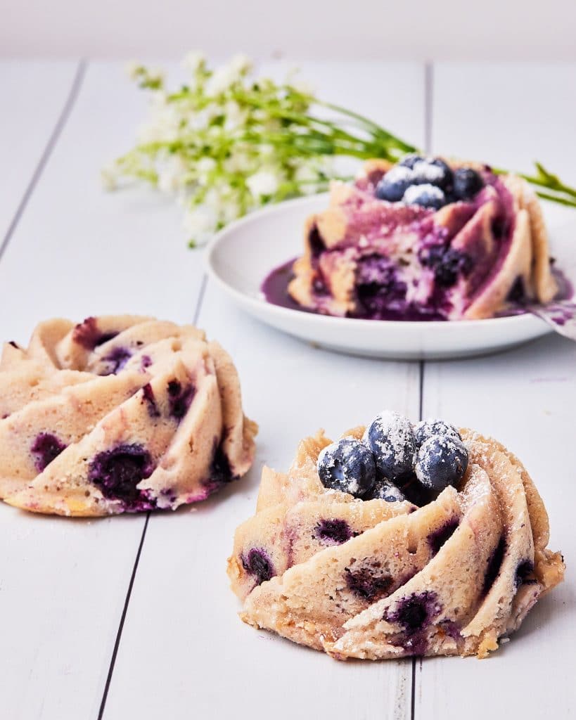 various blueberry bundt cakes with different toppings