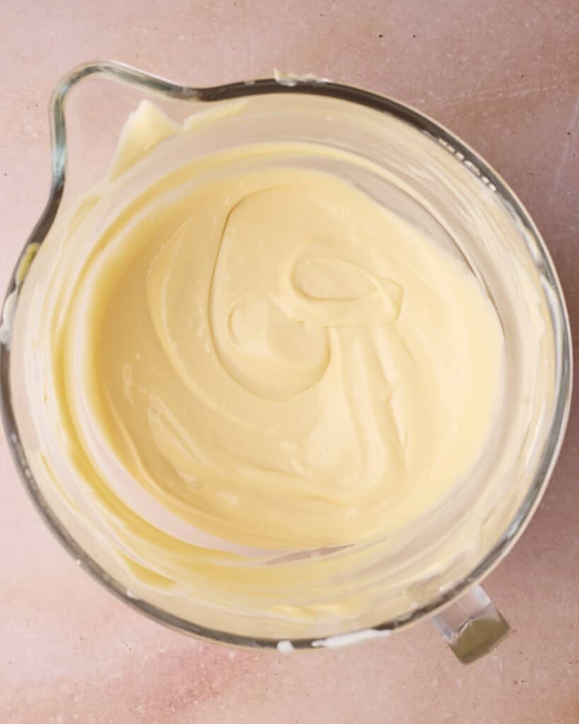 Cheesecake batter in a glass mixing bowl.
