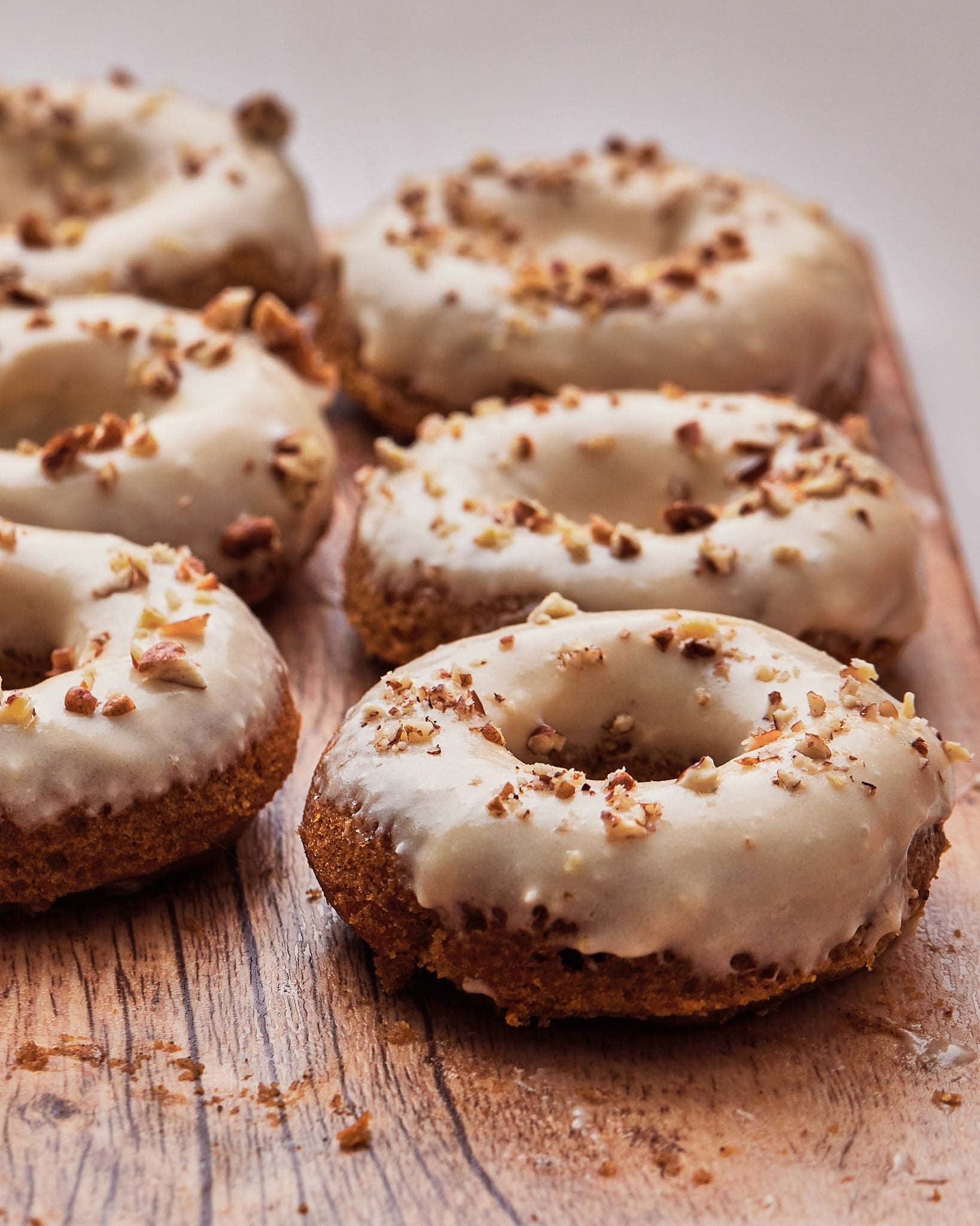 Pumpkin spice donuts covered in maple cream cheese glaze.