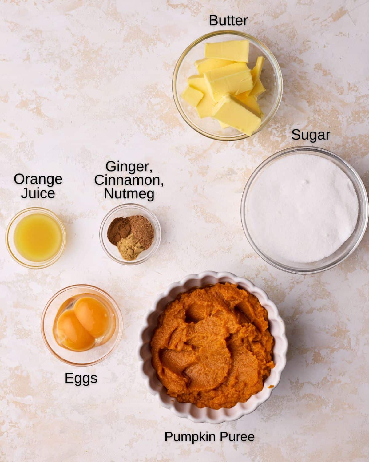 Ingredients to make pumpkin curd - pumpkin puree, butter, eggs, egg yolks, sugar orange juice and warm spices.