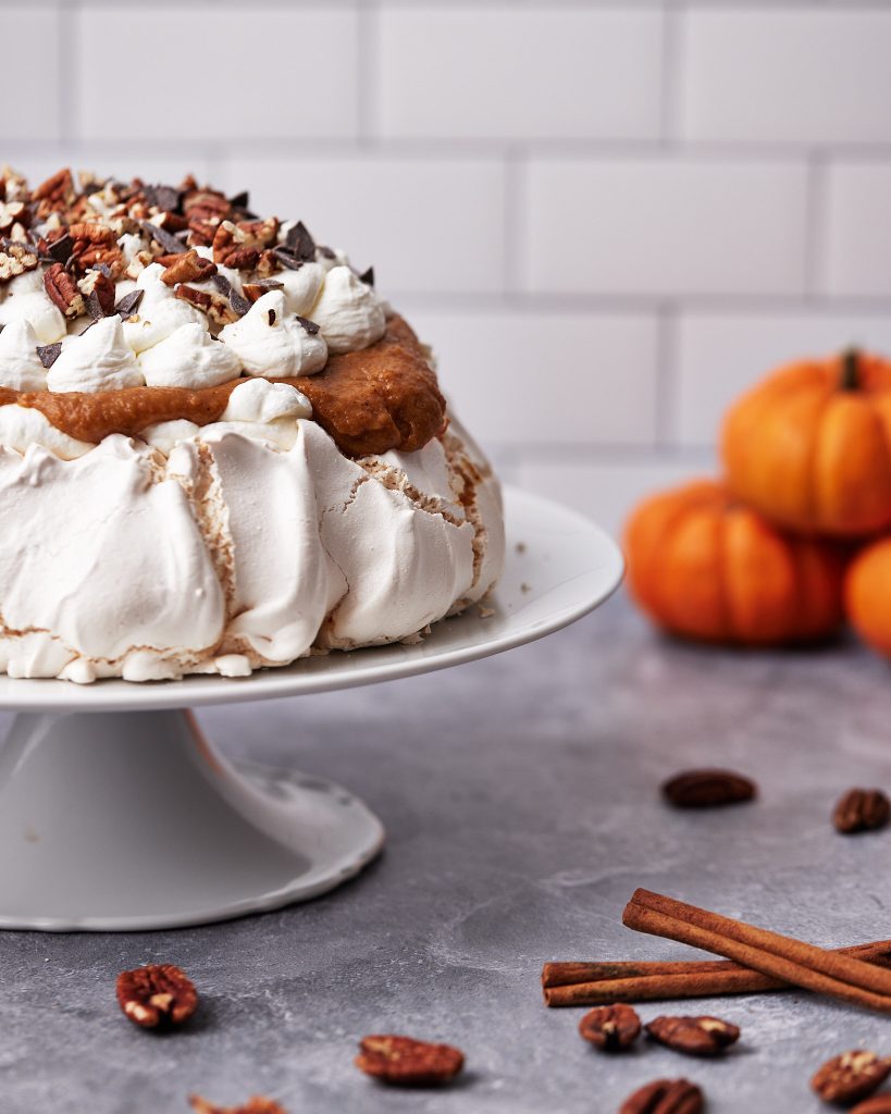 pumpkin pavlova with pumpkin spice curd, whipped cream and pecans