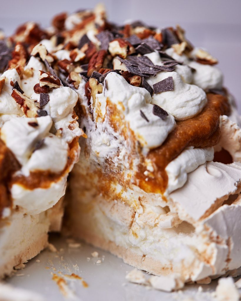 Gooey pumpkin pavlova with slice out of it