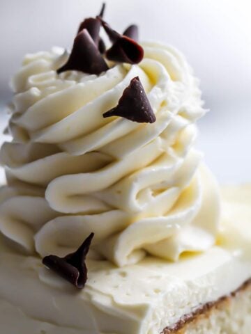 German buttercream (custard buttercream) piped on top of a custard cake in a swirl.