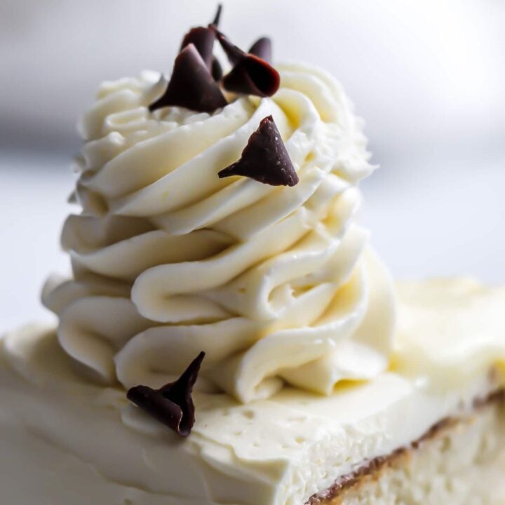 German buttercream (custard buttercream) piped on top of a custard cake in a swirl.