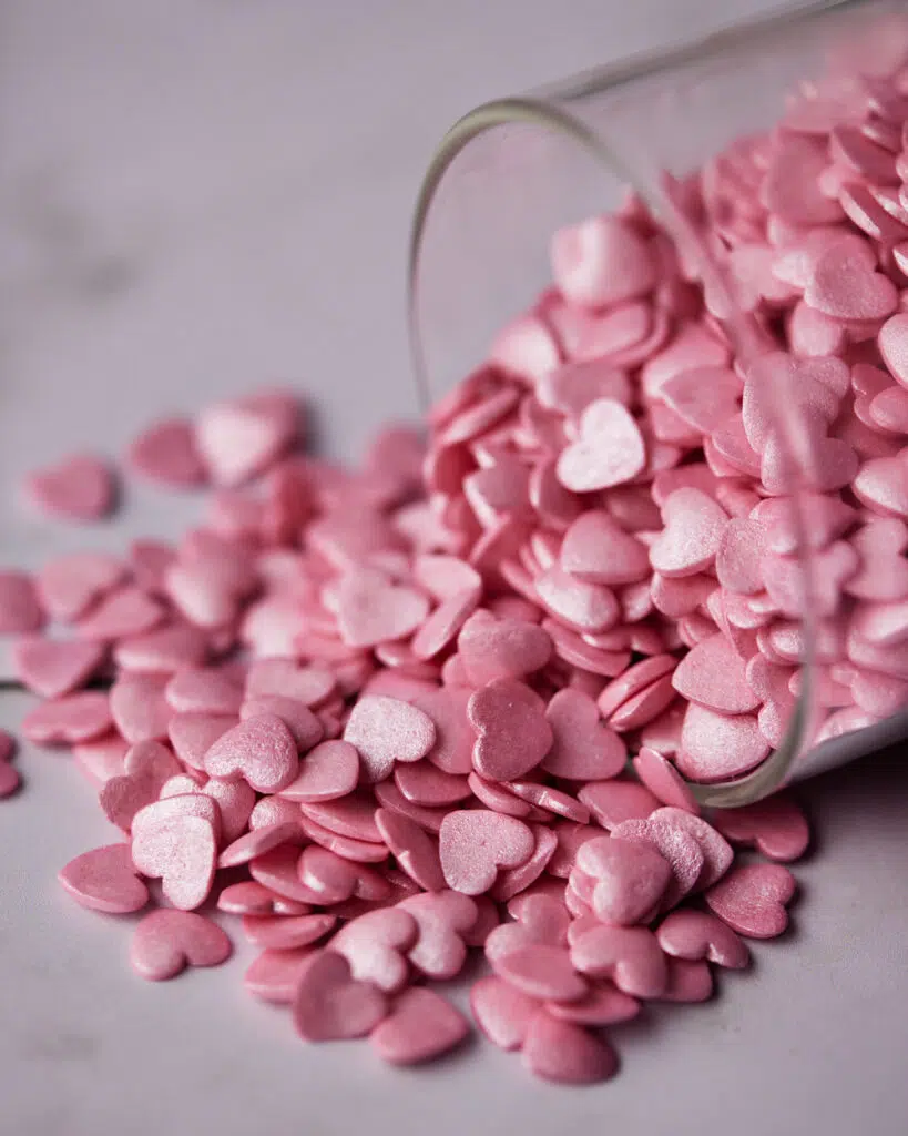 close up of shimmer pink heart sprinkles