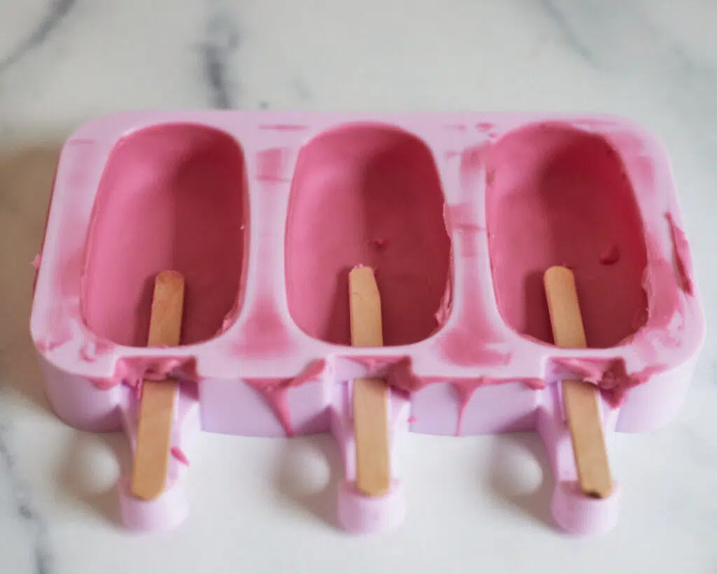 popsicle sticks inserted into cakesicle mold