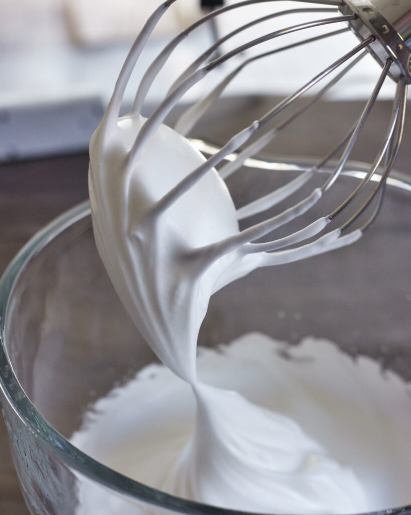 process shot of making italian meringue buttercream at soft peaks