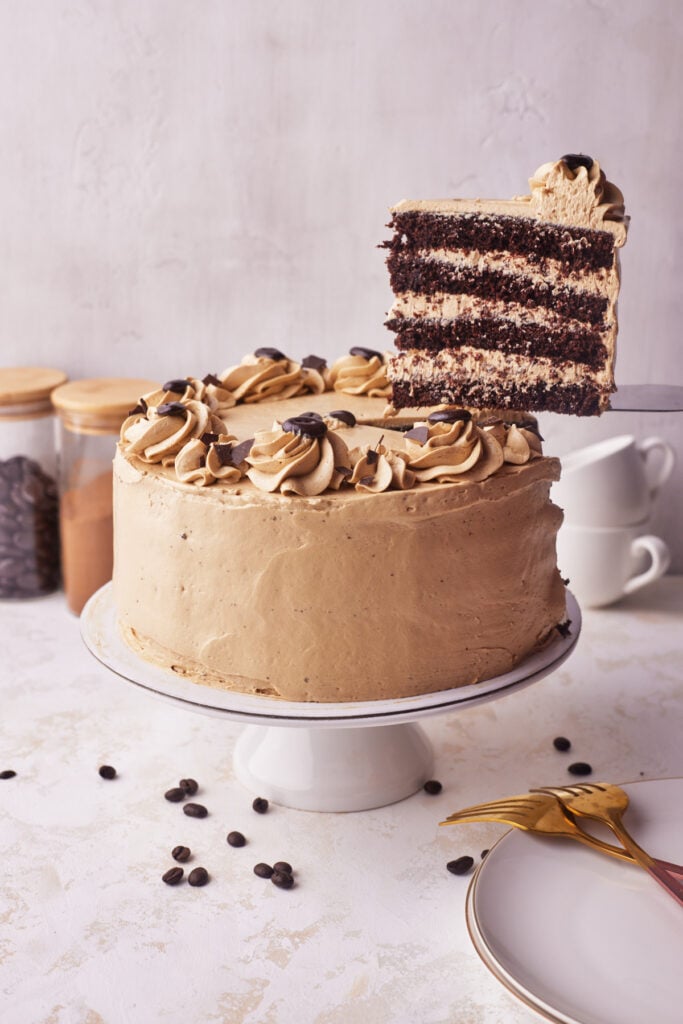 slice of chocolate espresso cake being lifted out of cake. 