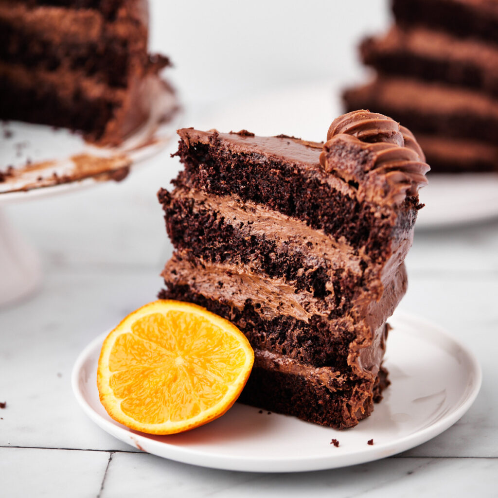 slice of chocolate orange cake with chocolate orange frosting