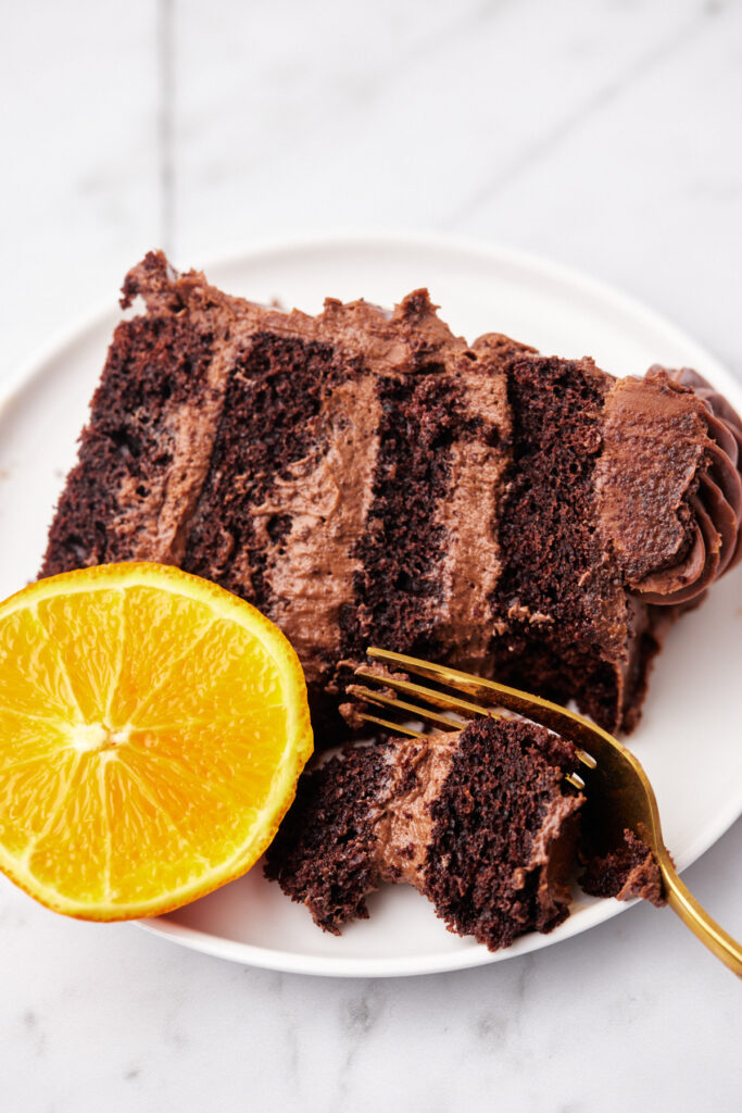 chocolate orange layer cake being eaten with a fork