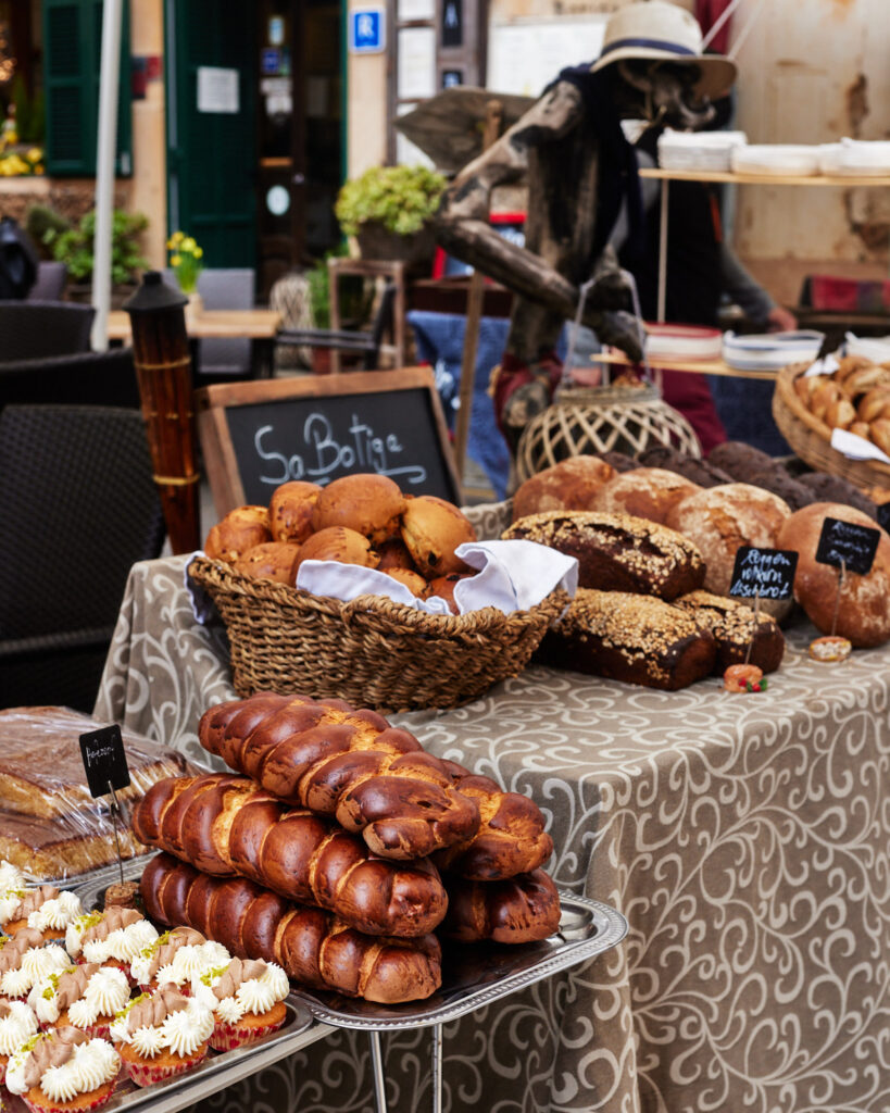 freshly baked breads and pastries at farmers market in santanyi, mallorca.