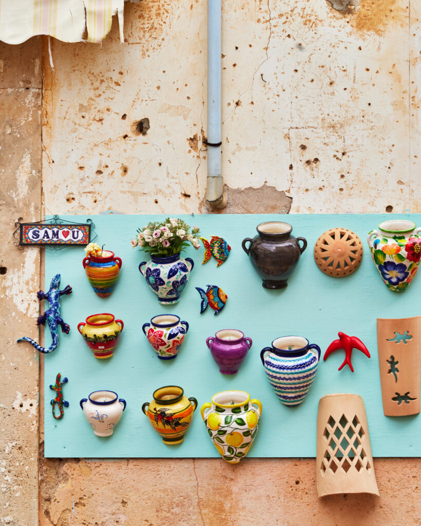 Colourful pots mounted on a wall at farmers market in mallorca.