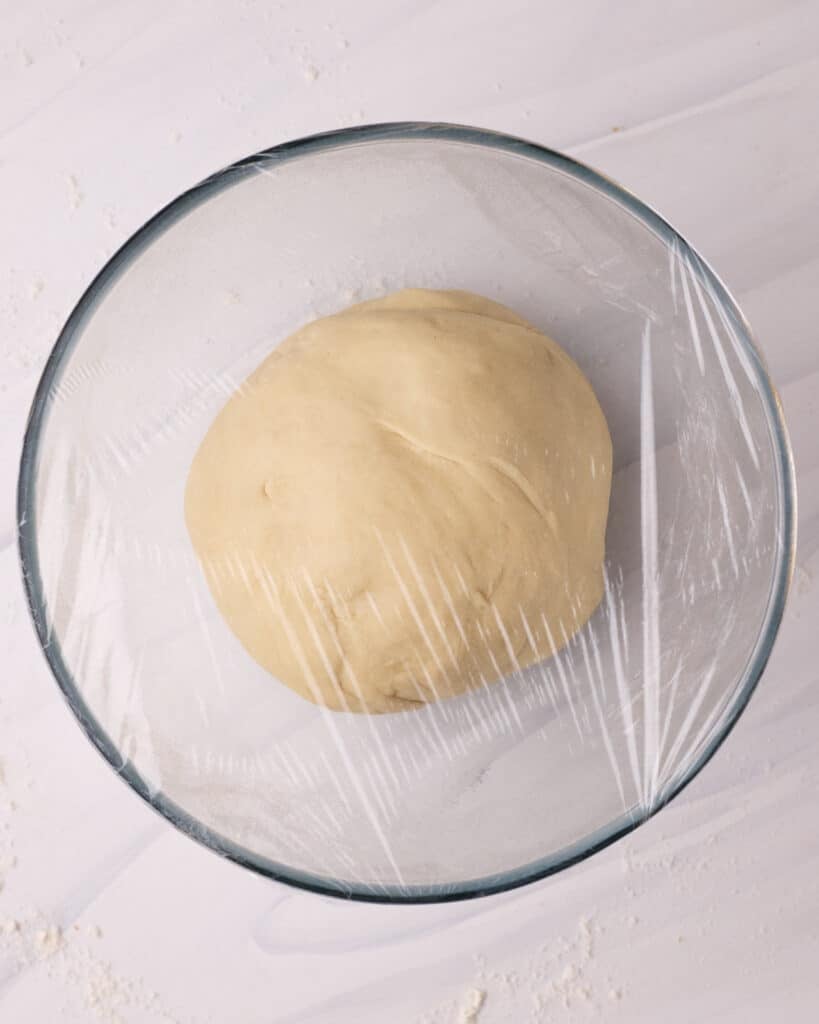 Kneaded donut dough in a bowl ready to proof.