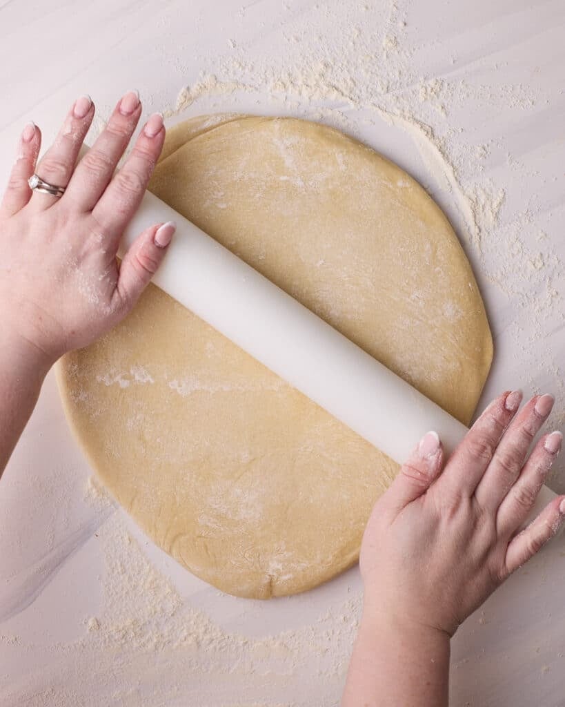 Rolling out donut dough to make Bavarian cream donuts. 