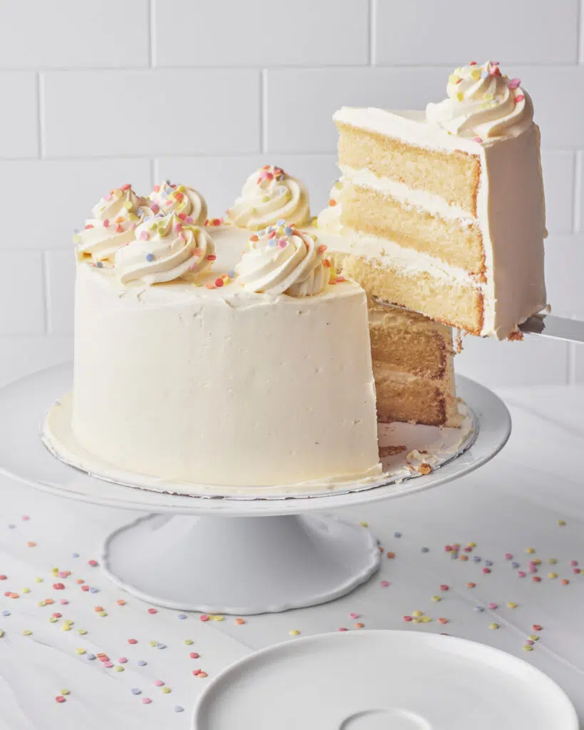 slice being taken out of french vanilla cake.
