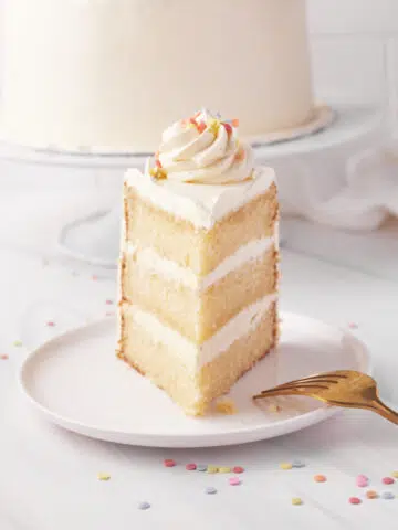 Single slice of french vanilla cake pointing towards the camera.