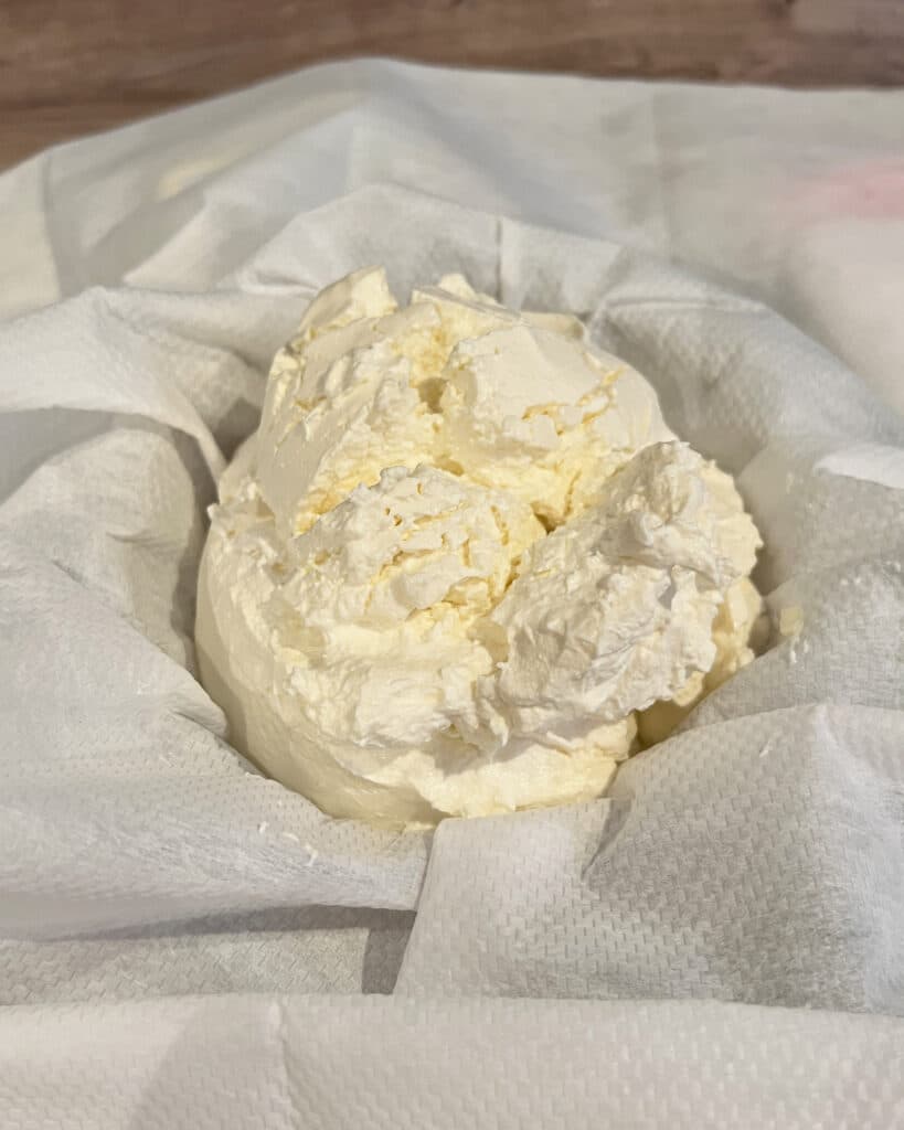 ricotta in a cheesecloth before being strained.