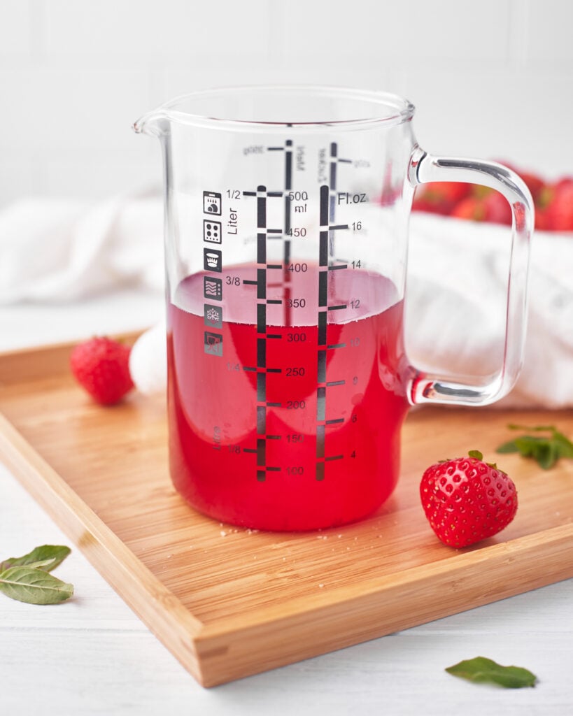 strawberry simple syrup in a glass jar. 