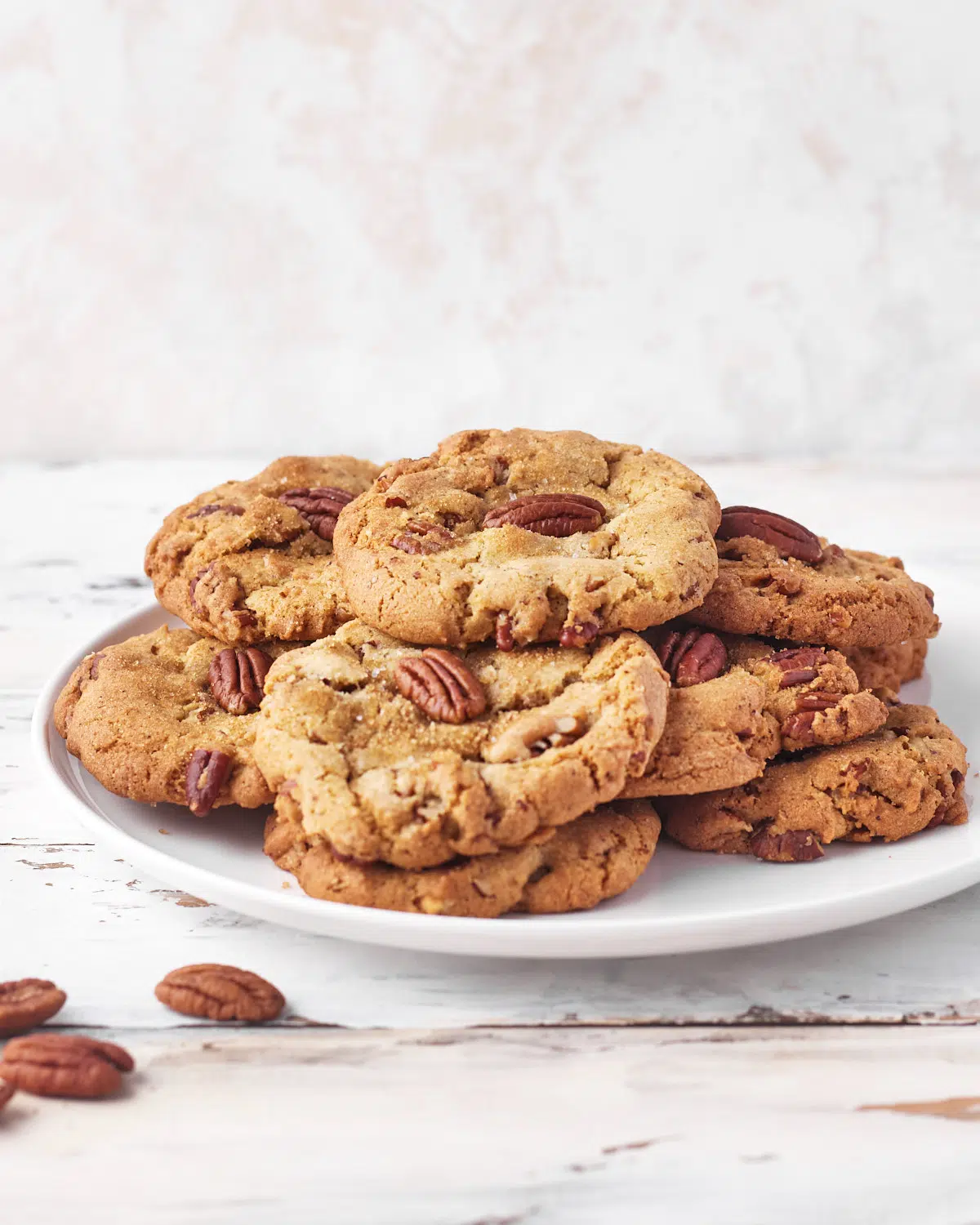 plate piled high with brown butter pecan cookies.