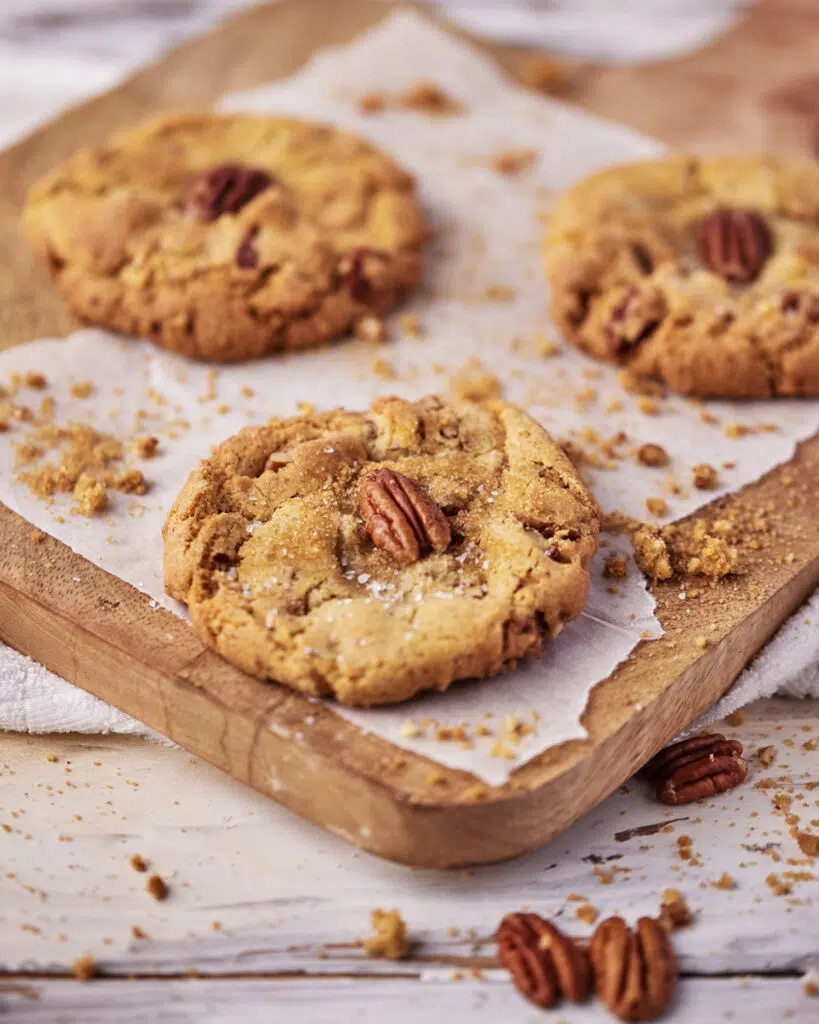 brown butter pecan cookies on a wooden platter.