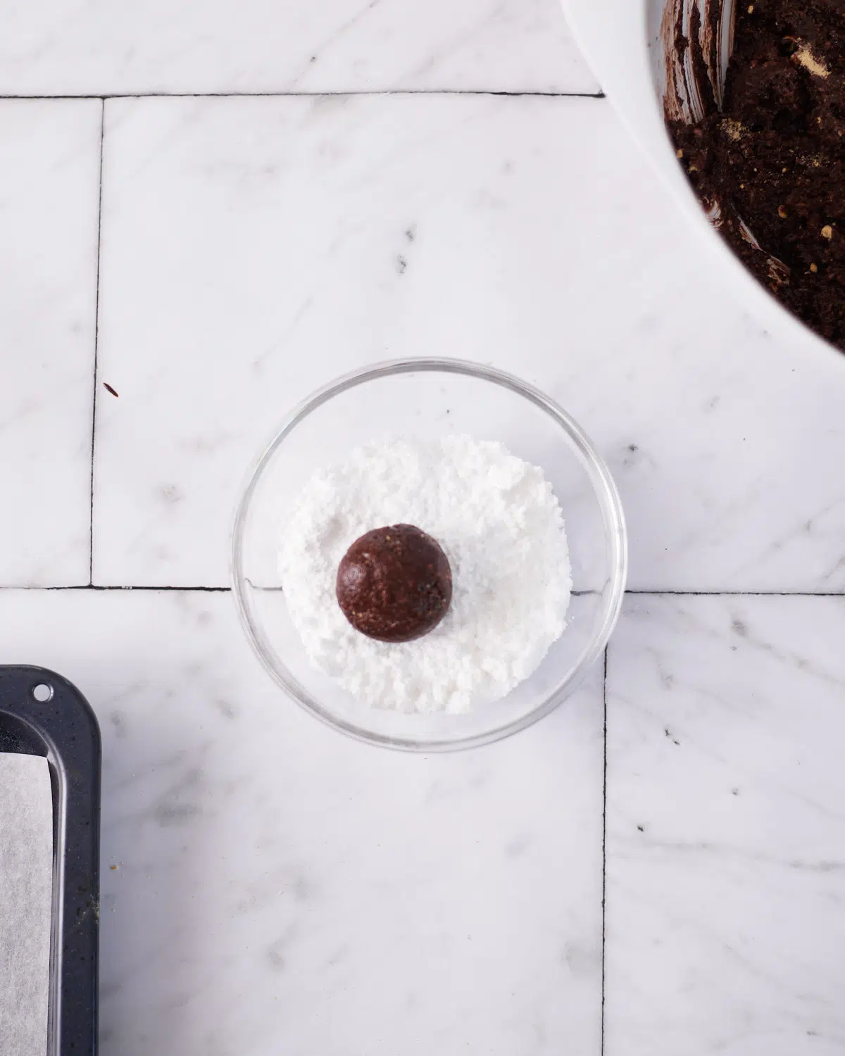 chocolate ball being rolled to make scottish truffles.