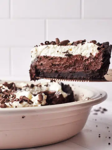 French silk pie being taken out of pie dish.