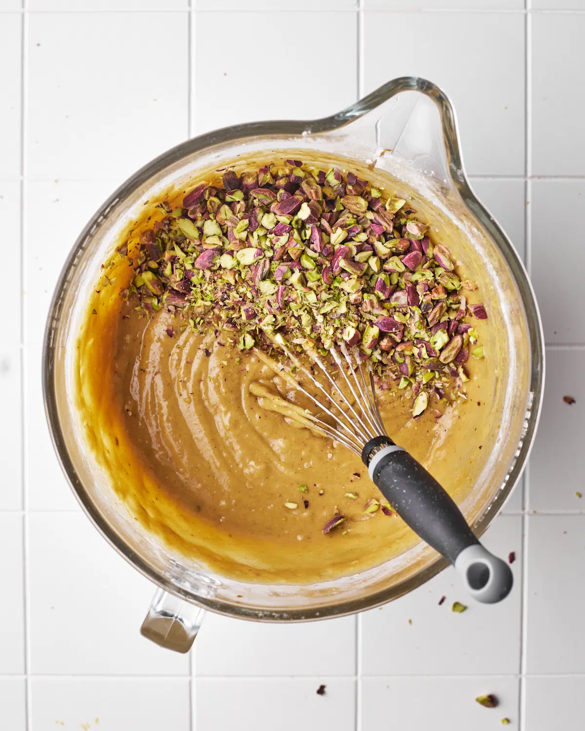 chopped pistachios in pistachio muffin batter - process shot.