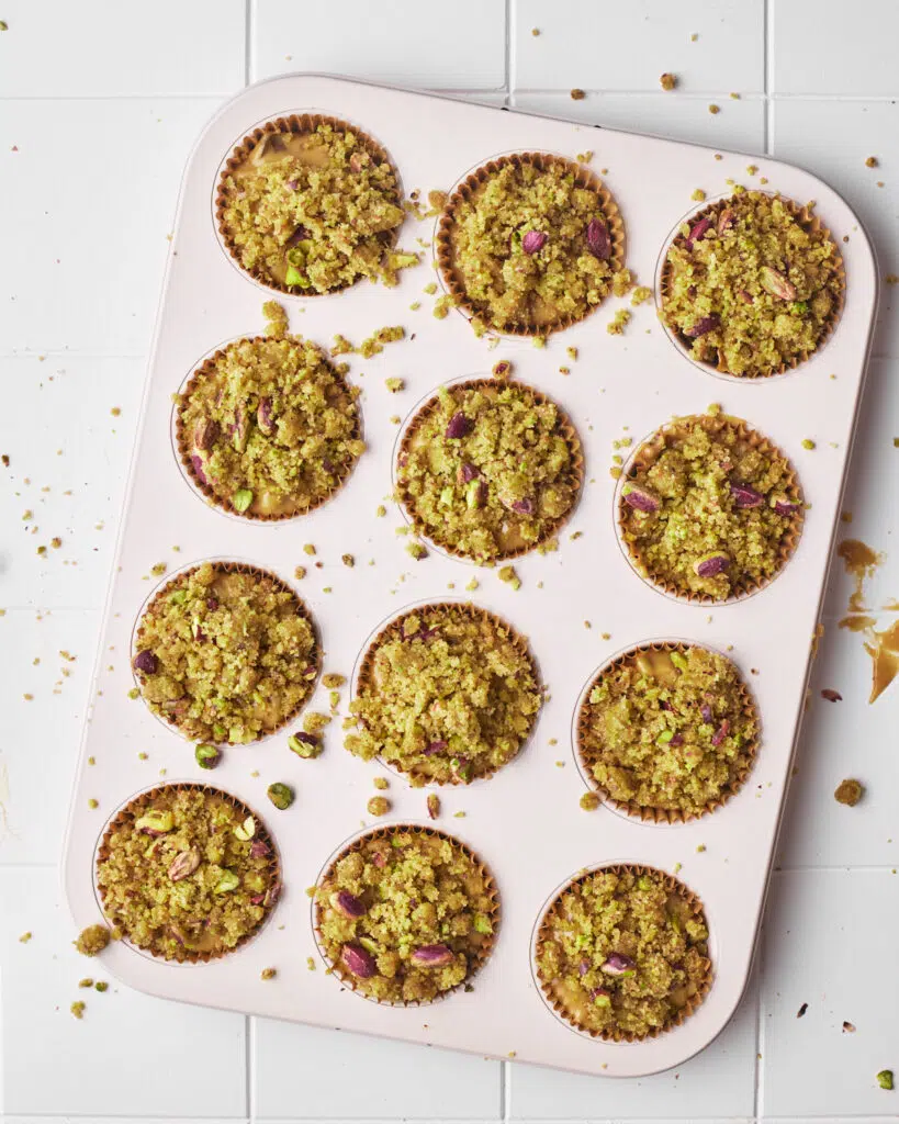 pistachio muffins topped with pistachio streusel, ready to be baked.