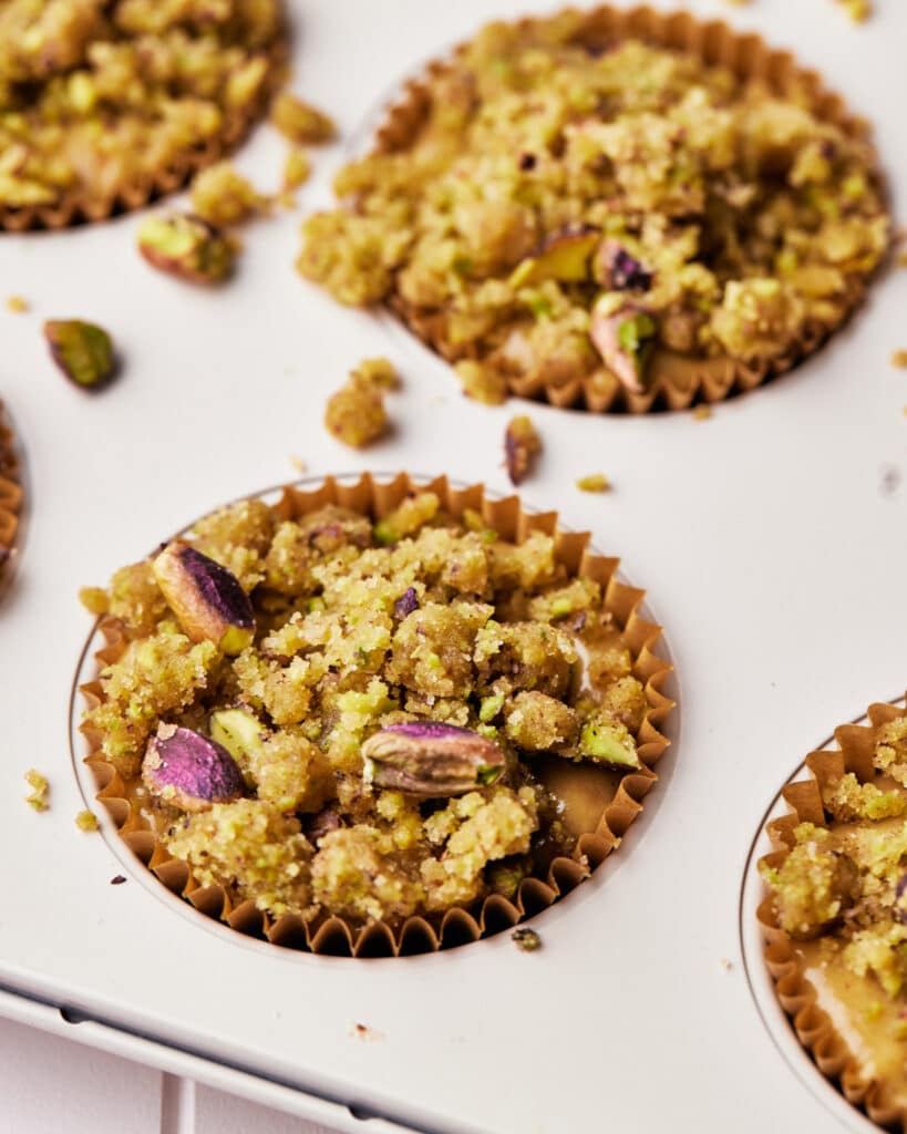 close up of pistachio crumble topping on pistachio muffins.